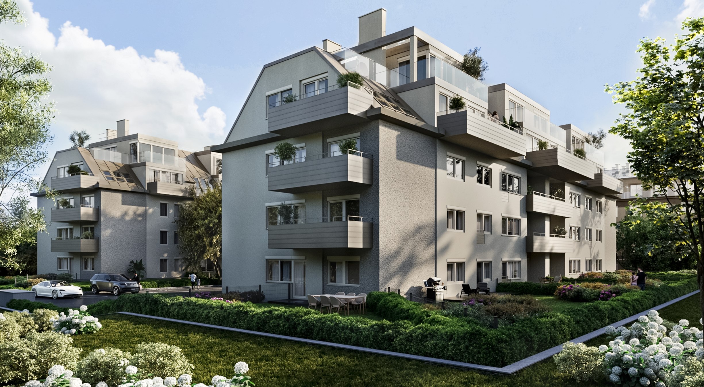 Blick auf die zwei Baukörper von "Am Hain". Diese haben großzügige Balkone, begrünte Außenbereiche und eine harmonische Architektur .
